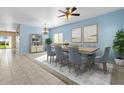 Light and airy dining room with a light wood table and blue chairs at 29061 N Cactus Cir, San Tan Valley, AZ 85143