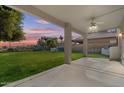 Covered patio overlooking a grassy backyard with a hot tub at 29061 N Cactus Cir, San Tan Valley, AZ 85143