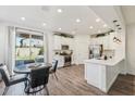 Bright kitchen with white cabinets, stainless steel appliances, and backyard access at 4026 E Madre Del Oro Dr, Cave Creek, AZ 85331