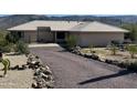 One-story home with a tile roof and mountain views in the background at 45239 N 16Th St, New River, AZ 85087