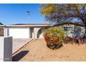 House exterior featuring a white garage door and landscaping at 4538 W Sierra St, Glendale, AZ 85304