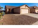 One-story house with a two-car garage and rock landscaping at 521 W Jardin Loop, Casa Grande, AZ 85122