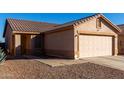 One-story house with a two-car garage and rock landscaping at 521 W Jardin Loop, Casa Grande, AZ 85122