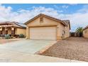 Charming single story home featuring a two car garage and desert landscaping at 521 W Jardin Loop, Casa Grande, AZ 85122