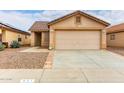 Charming single story home featuring a two car garage and desert landscaping at 521 W Jardin Loop, Casa Grande, AZ 85122