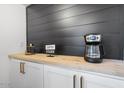 Modern coffee bar with wood countertop, built-in cabinets, and coffee maker at 5238 N 42Nd Ln, Phoenix, AZ 85019