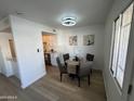 Bright dining area with a glass table and four chairs, adjacent to kitchen at 5238 N 42Nd Ln, Phoenix, AZ 85019