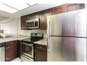 Kitchen with stainless steel appliances and dark wood cabinets at 534 S Palo Verde Way, Mesa, AZ 85208