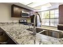 Modern kitchen features a granite countertop and stainless steel sink at 534 S Palo Verde Way, Mesa, AZ 85208