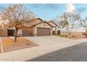 Two-story house with a three car garage and driveway at 5711 W Lydia Ln, Laveen, AZ 85339