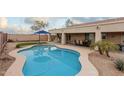 Inviting kidney-shaped pool with a large patio at 5711 W Lydia Ln, Laveen, AZ 85339