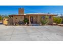 Front view of a charming single-story home with a large driveway at 617 S Camino Saguaro --, Apache Junction, AZ 85119