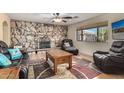 Relaxing living room with a stone fireplace and leather armchairs at 617 S Camino Saguaro --, Apache Junction, AZ 85119