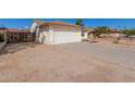 View of the garage and driveway with a side gate at 6602 W Desert Cove Ave, Glendale, AZ 85304