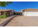 Landscaped yard with a gated side entrance to the property at 6602 W Desert Cove Ave, Glendale, AZ 85304