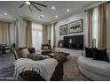 Bright living room featuring leather furniture, a large TV and access to backyard at 8136 E Beardsley Rd, Scottsdale, AZ 85255