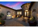 Charming courtyard with fountain, seating area, and mature plants at 8429 W Sands Ct, Peoria, AZ 85383