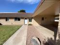 Front view of house with walkway leading to entrance and carport at 9814 N Balboa Dr, Sun City, AZ 85351