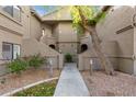 Condo building exterior showing walkway and landscaping at 15225 N 100Th St # 2187, Scottsdale, AZ 85260