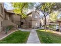 Exterior view of condo building with walkway and landscaping at 15225 N 100Th St # 2187, Scottsdale, AZ 85260