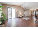 Spacious living room with hardwood floors and a ceiling fan at 15977 W Latham St, Goodyear, AZ 85338