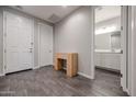 Inviting entryway features wood-look tile and a view to a bathroom with a white vanity at 18147 N Bell Pointe Blvd, Surprise, AZ 85374