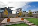 Backyard patio with pergola, artificial turf, and raised planter boxes at 19563 W Annika Dr, Litchfield Park, AZ 85340