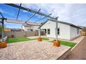 Backyard patio with pergola and artificial turf at 19563 W Annika Dr, Litchfield Park, AZ 85340