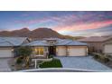 Beautiful home featuring desert landscaping, a three-car garage, stone accents, and mountain views at 32722 N 132Nd Ln, Peoria, AZ 85383