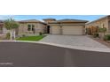 Beautiful home featuring desert landscaping, a three-car garage, and a curved driveway at 32722 N 132Nd Ln, Peoria, AZ 85383