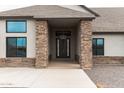 Front entry with stone pillars and a modern door at 34949 N Donald Way, San Tan Valley, AZ 85140