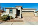 Modern single story home with tan garage door and neutral color scheme at 40108 W Crane Dr, Maricopa, AZ 85138