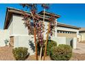 Landscaped home exterior with a two-car garage and desert landscaping at 40108 W Crane Dr, Maricopa, AZ 85138