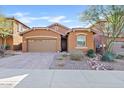 Tan house with a three-car garage and nicely landscaped front yard at 4127 W Granite Basin Dr, New River, AZ 85087