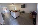 Bright living room with gray tile floors and a large TV at 5128 S 6Th St, Phoenix, AZ 85040