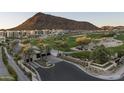 Gated community entrance with lush landscaping and golf course at 6311 E Phoenician Blvd # 19, Scottsdale, AZ 85251