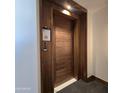 Stylish wood door entrance, providing privacy and security to the condo residence at 6587 N Palmeraie Blvd # 2022, Paradise Valley, AZ 85253