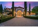 Mediterranean-style home with lush landscaping and brick driveway at 6800 E Caballo Dr, Paradise Valley, AZ 85253