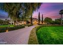 Grand estate entrance with paved driveway and lush landscaping at 6800 E Caballo Dr, Paradise Valley, AZ 85253