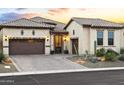 Tan stucco home with brown garage doors and desert landscaping at 8433 E Leonora St, Mesa, AZ 85207