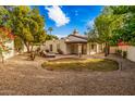 Large backyard with grassy area, gravel, and a lounge chair at 9426 S 47Th Pl, Phoenix, AZ 85044