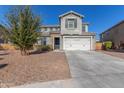 Two-story home with gray siding, white garage door, and landscaping at 9654 W Weeping Willow Rd, Peoria, AZ 85383