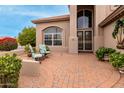 Brick paved patio with seating area and lush landscaping at 10035 E Diamond Dr, Sun Lakes, AZ 85248