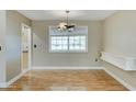 Spacious dining area with large window and contemporary chandelier at 10252 N 105Th Dr, Sun City, AZ 85351