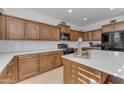 Modern kitchen with white quartz countertops and wood cabinets at 10307 E Nopal Ave, Mesa, AZ 85209