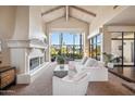 Bright living room with a fireplace and water views at 10489 N 99Th St, Scottsdale, AZ 85258