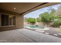 Covered patio overlooking the pool and backyard with citrus trees at 1060 W Silver Creek Rd, Gilbert, AZ 85233