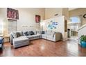 Spacious living room with L-shaped sectional sofa and hardwood floors at 11025 W Lane Ave, Glendale, AZ 85307