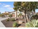 View of home's side elevation, showcasing landscaping and desert plants at 122 E Orange Blossom Path, Queen Creek, AZ 85140