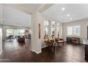 Open living space with dark hardwood floors, and view into kitchen area at 122 E Orange Blossom Path, Queen Creek, AZ 85140